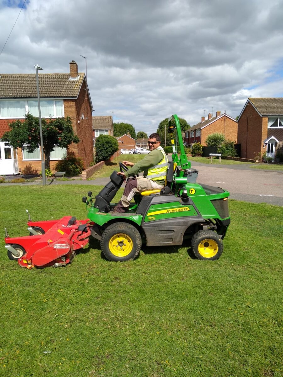 Outdoor team member on sit on mower