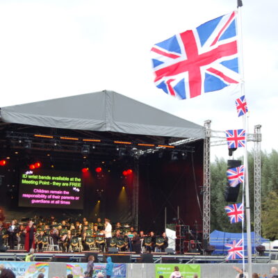 Proms in the park stage with flag